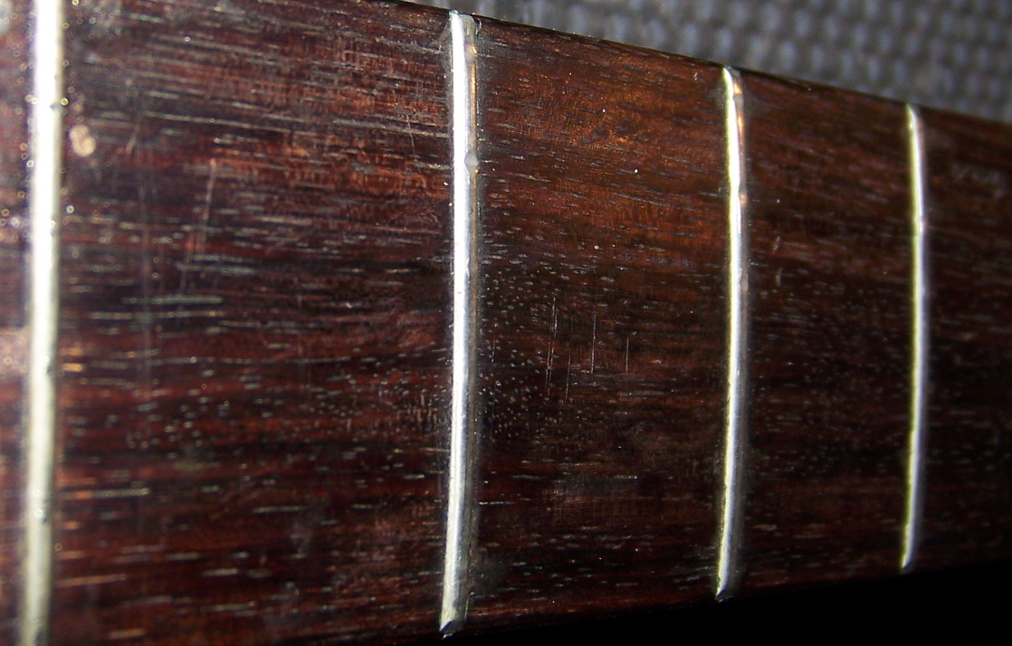 Frets with obvious grooves from wear